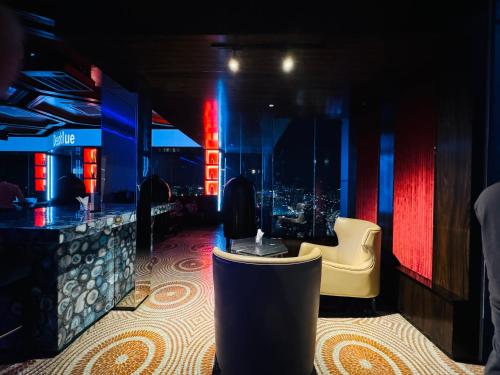 a restaurant with a bar with a view of a city at THE PLATINUM KLCC by COZY STAY in Kuala Lumpur