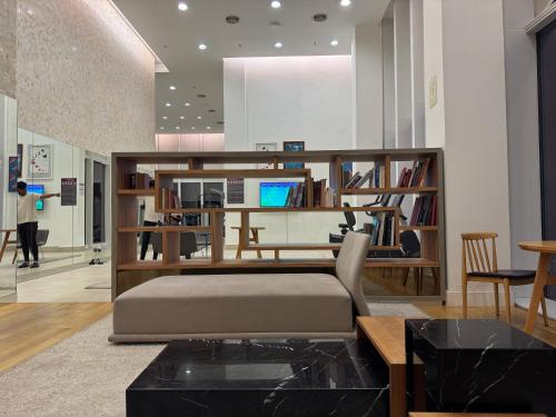 a living room with a bed and a desk at THE PLATINUM KLCC by COZY STAY in Kuala Lumpur