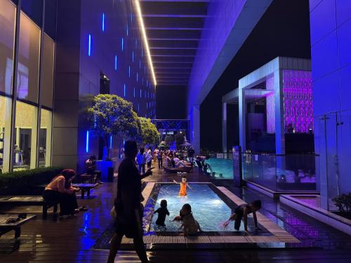 a group of people playing in a pool in a building at THE PLATINUM KLCC by COZY STAY in Kuala Lumpur