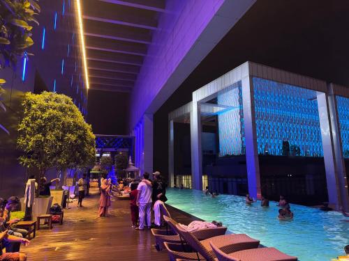 a swimming pool in a building with people in the water at THE PLATINUM KLCC by COZY STAY in Kuala Lumpur