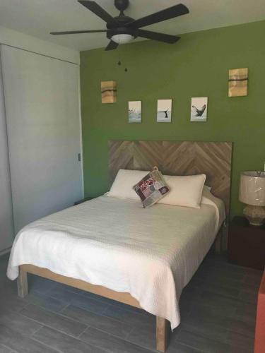 a bedroom with a bed with a ceiling fan at La Hidalgo, Departamento A in Chapala