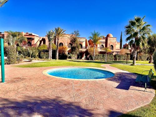 a small swimming pool in front of a house at Duplex Luxe avec Rooftop, 3 Piscines, 2 Chambres, Atlas Golf Marrakech in Marrakech