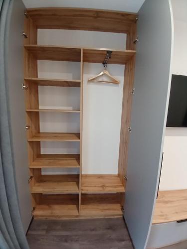 a closet in a room with wooden shelves at EcoBerghaus - Котеджне містечко in Bukovel