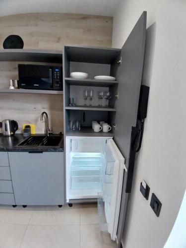 a small kitchen with a refrigerator and a sink at EcoBerghaus - Котеджне містечко in Bukovel