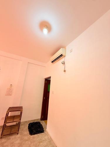 an empty room with a door and a chair at Utopia Hikka in Hikkaduwa