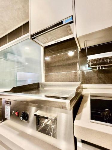 a kitchen with a stove top oven in a kitchen at Beaver Stay, Bosu in Busan