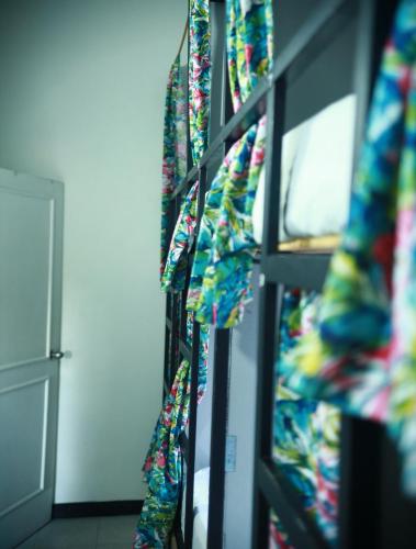 a room with a bunch of wrapping paper on a wall at Baku Laureles Hostel in Medellín
