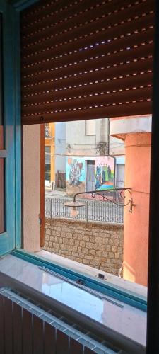 a window of a building with a view of a street at Sa Omu 'Eccia in Villagrande Strisaili