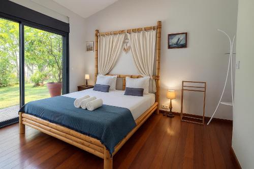 a bedroom with a bed with two towels on it at Villa O'rizon Bleu - Piscine XXL et vue mer panoramique sur St Gilles les Bains in Saint-Gilles les Bains