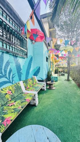a building with umbrellas on the side of it at Baku Laureles Hostel in Medellín