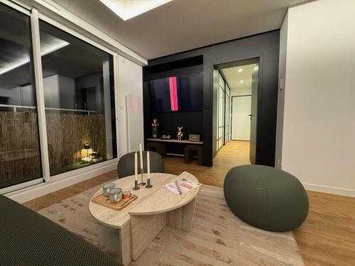 a living room with a table and two chairs at Appartement d'architecte face à la mer in Les Sables-dʼOlonne