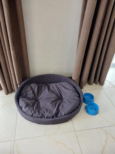 a dog bed sitting on the floor in a room at EcoBerghaus - Котеджне містечко in Bukovel