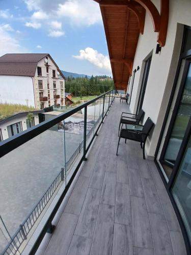 a balcony with a view of the water at EcoBerghaus - Котеджне містечко in Bukovel