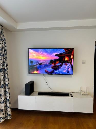 a living room with a flat screen tv on a wall at The Alma Luxe Modern 1 bedroom Apartment in Ruaka