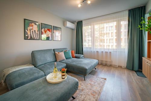 a living room with a couch and a table at TRINAVIS Boutique Apartments, OWN PRIVATE PARKING, City Center, Entire Apartment in Veliko Tŭrnovo