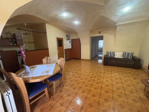 a living room with a table and a couch at Apartament central zone in Sibiu