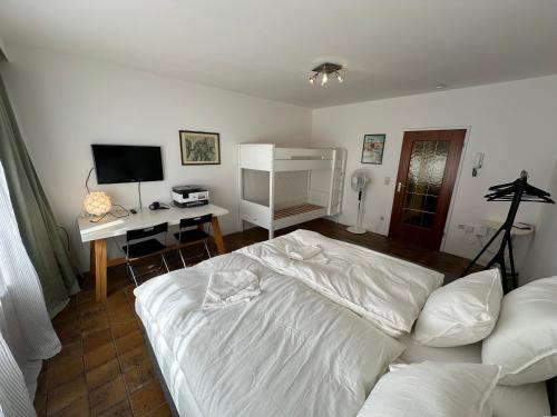 a bedroom with a bed and a desk with a computer at Centrally located apartment Luxembourg in Luxembourg