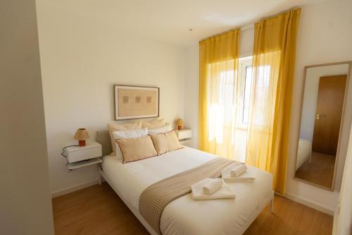 a bedroom with a bed with two towels on it at BV 01 Apartment in Amadora