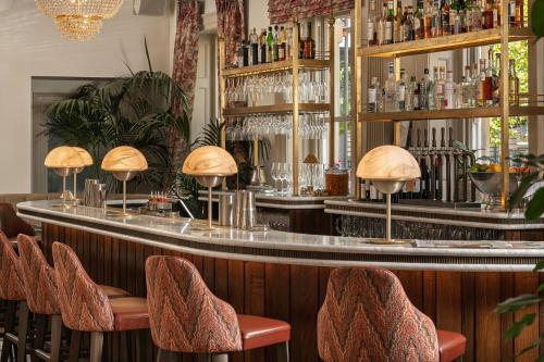 a bar with a counter with stools in a restaurant at Francis Hotel Bath in Bath