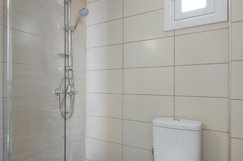 a bathroom with a shower and a toilet at Frantzis Studio 2 - Nisyros in Páloi