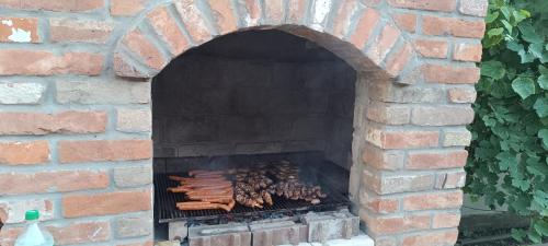 a brick oven with a bunch of food on it at Petrovaradinski Dvor in Petrovaradin