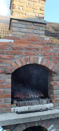 a brick oven with a fire inside of it at Petrovaradinski Dvor in Petrovaradin
