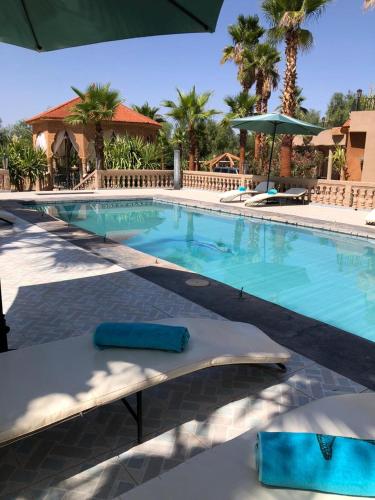 a swimming pool with blue water in a resort at Eden Suites 