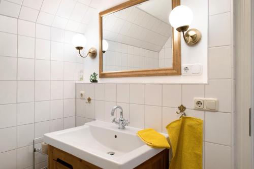 a bathroom with a sink and a mirror at Altes Polchower Pfarrhaus 