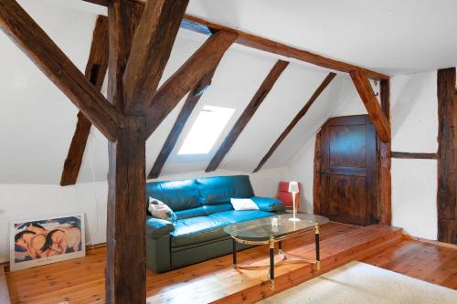 a living room with a blue couch and a glass table at Altes Polchower Pfarrhaus 