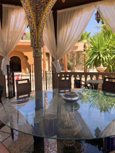 a glass table in the middle of a patio at Eden Suites 