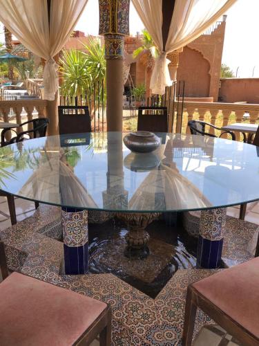a glass table in a room with tables and chairs at Eden Suites 