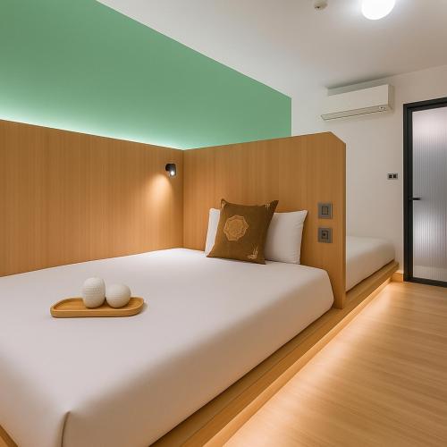 Postel nebo postele na pokoji v ubytování Moonsset INN Taitung