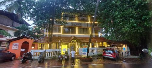 a house with a car parked in front of it at Hotel Susegad Retreat in Candolim