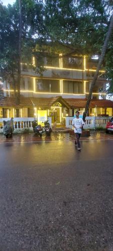 a man riding a skateboard down a street at night at Hotel Susegad Retreat in Candolim