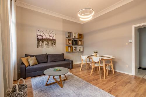 a living room with a couch and a table at Family Apartment in Wiesbaden