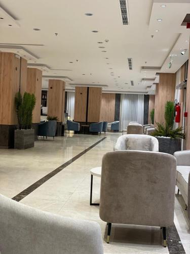 a lobby with chairs and tables in a building at فندق رافيليا Rafellia Hotel in Ahad Rafidah