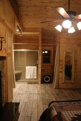 a bathroom in a log cabin with a shower and a tub at Modern Cabin on wooded 20 acres with scenic view in Nancy, KY in Nancy