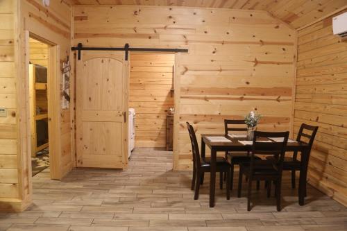 a dining room with a table and chairs at Modern Cabin on wooded 20 acres with scenic view in Nancy, KY in Nancy