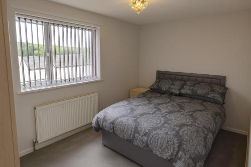 a bedroom with a bed and a window at Cosy 3 Bed House, Decked Garden, Free Parking in Central Station