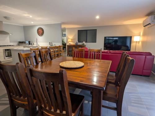 a dining room and living room with a table and chairs at Spacious 4x2 Southwest Gem Perfect for Two Families, Steps from Top Attractions with Fun Spaces for Kids, separate areas for Adults and Big Savings in Vasse