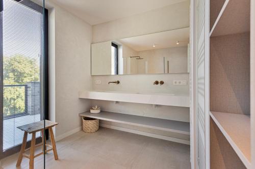 a bathroom with a sink and a mirror at Faro Greenpark, Cadzand-Bad Penthouse in Cadzand