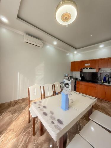 a kitchen with a table and chairs in a room at Phuong Linh Beach Villa in Nha Trang