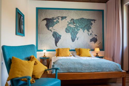 a bedroom with a map of the world on the wall at Art'e Boutique Rooms in Băile Tuşnad