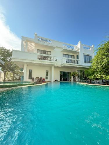 a large swimming pool in front of a building at Phuong Linh Beach Villa in Nha Trang