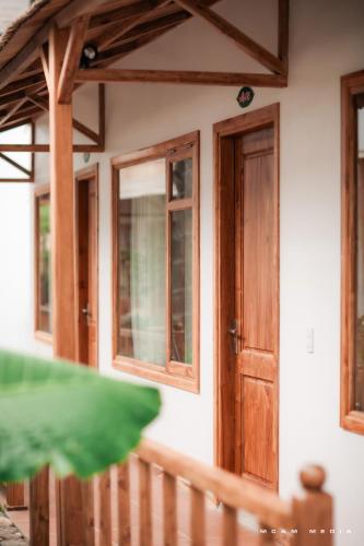 a house with a wooden door and windows at Lá Nhỏ Homestay Mộc Châu in Mộc Châu
