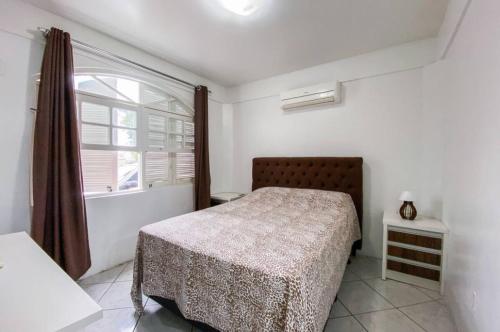 una camera da letto con un letto e una finestra di cód 164 - Casa de Praia com Piscina a Governador Celso Ramos