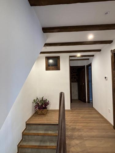 a staircase in a house with white walls and wooden floors at Casa Dulcinea en Brañosera in Brañosera