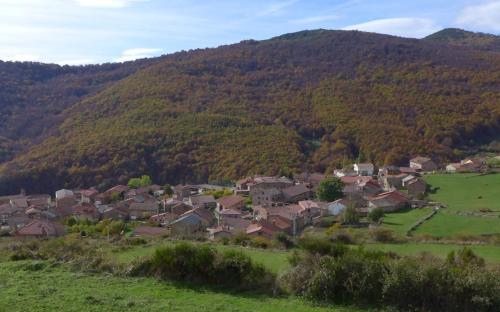 a group of houses in a field in a mountain at Casa Dulcinea en Brañosera in Brañosera