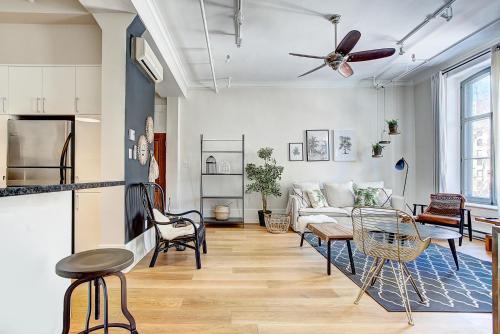 a living room with a couch and a ceiling fan at The SFX Old Port in Montréal