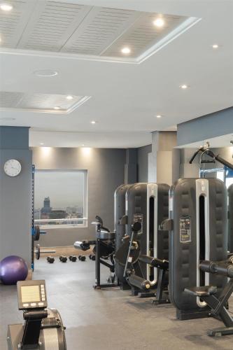 a gym with treadmills and weights in a room at NH Collection Plaza Santiago in Santiago
